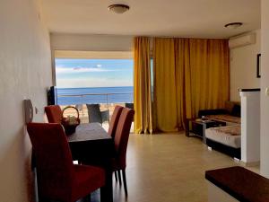 a living room with a table and a view of the ocean at Apartments Violeta in Budva