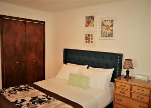 a bedroom with a bed with a black headboard and a dresser at Urbana in Grand Forks