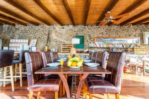 
a dining room table with chairs and a wooden table at Eco Village Finca De Arrieta in Tabayesco
