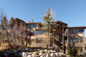 an exterior view of a large house with a tree at Aspenwood Studio with Loft- J12 in Snowmass Village