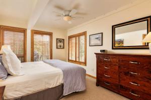 a bedroom with a bed and a dresser and a mirror at Interlude 103 in Snowmass Village