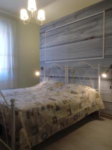 a bedroom with a bed with a wooden headboard at Terre di creta...per sognare in Pomaia