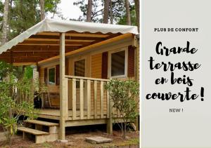 a tiny house with a porch and a sign that says garage franchisees are best at Mobil-home St Georges in Saint-Georges-de-Didonne