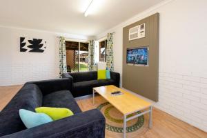 a living room with a couch and a table at Geraldton's Ocean West Holiday Units & Short Stay Accommodation in Geraldton