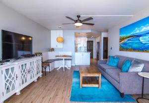 a living room with a couch and a table at Island Sands 505 in Maalaea