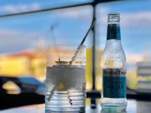 a bottle of water sitting next to a drink at Beach House I&II in Alykes