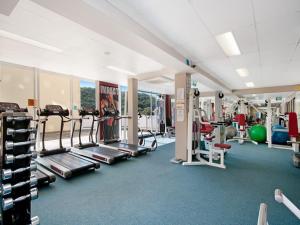 a gym with several treadmills and machines at Penthouse 707 - 4 Bedroom Oceanview Penthouse in Ettalong Beach