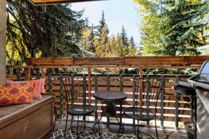 a patio with two chairs and a table on a balcony at Sagewood 8 in Aspen