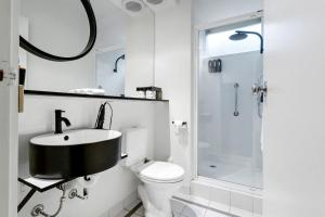 a bathroom with a sink and a toilet and a shower at SoYa on Davis Apartment Hotel in Melbourne +16 photos