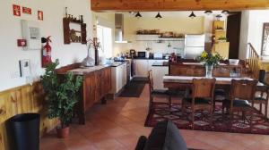 a kitchen with a table and a dining room at Quinta de Vodra in Seia