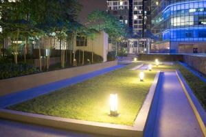 a park with lights in the grass at night at KL Top Location Kid's Theme White Collar Apartment in Kuala Lumpur