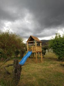 a playground with a blue slide and a gazebo at Quinta de Vodra in Seia