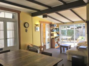 a living room with a wooden table and a couch at Anakiwa 401 in Anakiwa