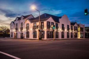 a white building with a green light on a street at The Salisbury Business Class in Christchurch