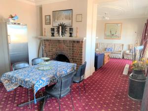 a dining room with a table and a fireplace at Ranfurly Hotel in Ranfurly