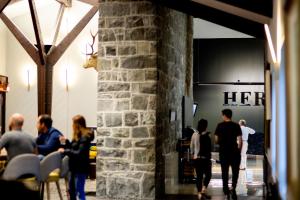 a group of people walking around a room with a store at The Hermitage Hotel Mt Cook in Mount Cook Village
