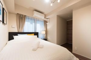 Postel nebo postele na pokoji v ubytování HIZ HOTEL Ginza