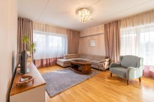 a living room with a couch and a tv at Tähe Apartment in Tartu