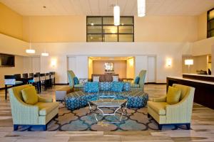 a living room filled with furniture and a large window at Holiday Inn Express Hotel & Suites Colorado Springs Downtown Central, an IHG Hotel in Colorado Springs