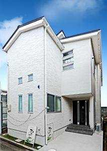 a white house with at Guest House Ochakare in Kanazawa