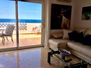 a living room with a couch and a view of the ocean at DUQUESA BY THES SEA - HACIENDA GUADALOUPE in Manilva