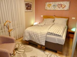 a bedroom with a bed and a table with a chair at Exklusives Wohnen am Stadtpark in Bad Driburg +13 photos