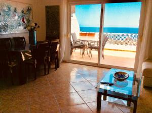 a living room with a table and a dining room at DUQUESA BY THES SEA - HACIENDA GUADALOUPE in Manilva