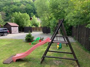 a playground with a slide in a yard at Chalet Milenium Residence Bran in Bran