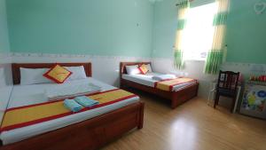 Säng eller sängar i ett rum på Trúc Nguyên - Vĩnh Hy Homestay