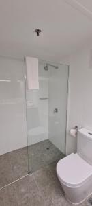 a white toilet sitting next to a shower in a bathroom at Best Western Plus Hotel Lord Forrest in Bunbury