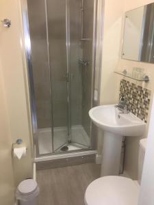 a bathroom with a shower and a sink at The Wilton Weymouth in Weymouth +118 photos