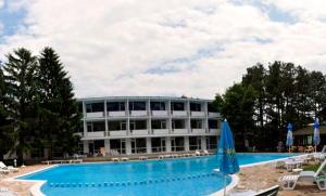 a large building with a swimming pool in front of it at Hotel Horizont in Golden Sands +18 photos