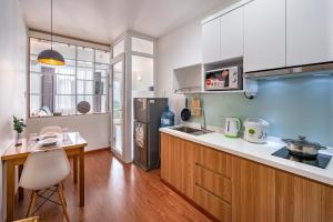 a kitchen with a refrigerator and a table in it at SaigonOne Serviced Apartment in Ho Chi Minh City
