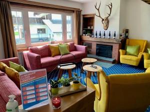 a living room with a couch and a table at Hotel Bünda Davos in Davos