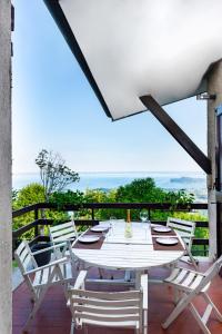 a table and chairs on a patio with a view of the ocean at Casa panoramica in Salò
