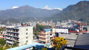 a view of a city with mountains in the background at Hotel Middle Path & Spa in Pokhara