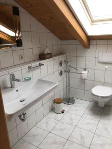 a bathroom with a sink and a toilet at Ferienwohnung-am-Chiemsee in Grabenstätt