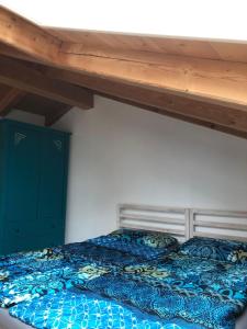a bedroom with a bed with a blue comforter at Ferienwohnung-am-Chiemsee in Grabenstätt