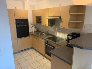 a small kitchen with a sink and a stove at Apartment Wanderglück am Gehrenberg in Markdorf