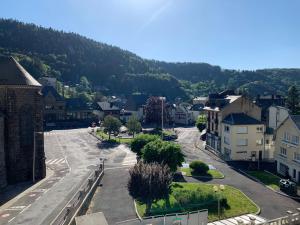 an empty street in a small town with a mountain at Duplex plein centre ville 3Etoiles in Le Mont-Dore