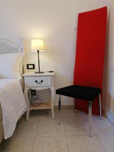 a bedroom with a bed and a table and a chair at Leone X Guest House in Florence