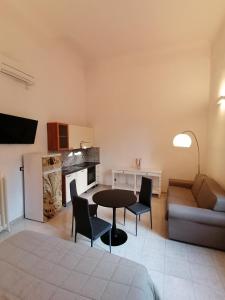 a living room with a table and chairs and a couch at Leone X Guest House in Florence