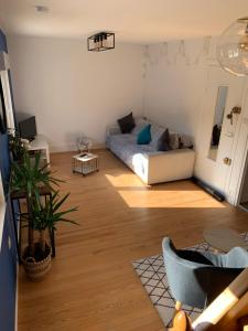 a living room with a couch and a table at Duplex plein centre ville 3Etoiles in Le Mont-Dore