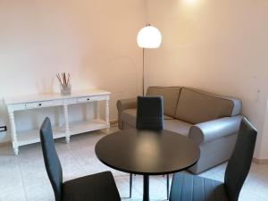 a living room with a couch and a table and chairs at Leone X Guest House in Florence +53 photos