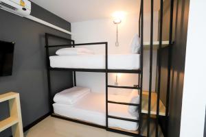 Rúm í herbergi á The Rest Hotel - ประจวบ