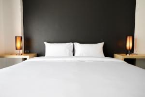 Rúm í herbergi á The Rest Hotel - ประจวบ
