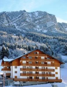 a large building in front of a mountain at Appartement de 2 chambres a Thollon les Memises a 500 m des pistes avec vue sur le lac et wifi in Thollon