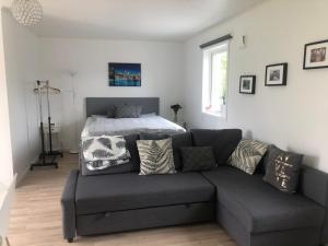 a living room with a couch and a bed at Great Stay Guest House Sandviken in Sandviken