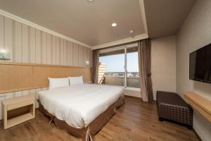 Krevet ili kreveti u jedinici u objektu Fish Hotel-Pingtung