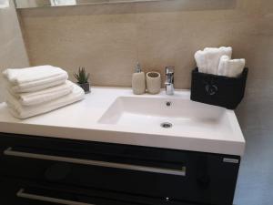 a bathroom with a sink with towels and a mirror at Apartments Antoana in Hvar +104 photos
